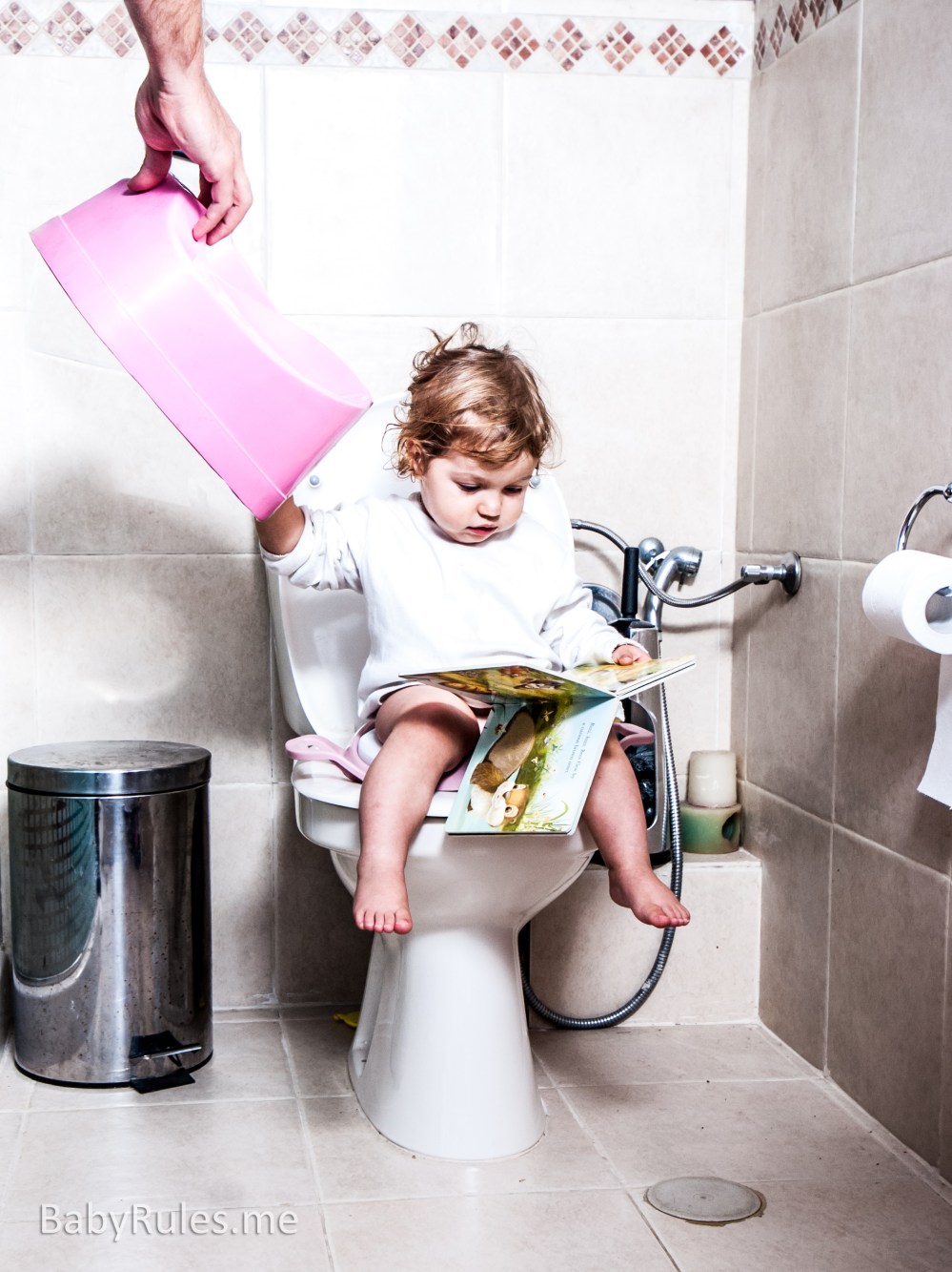 Baby םn toilet gives potty to dad