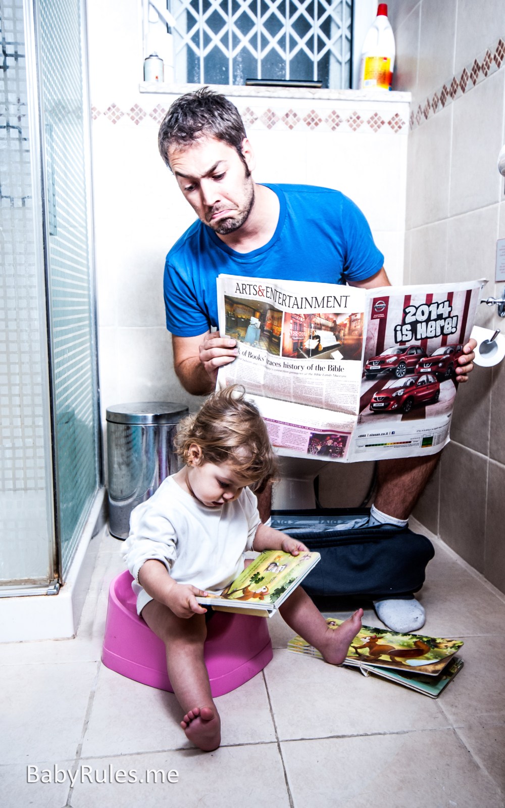 father and daughter in toilet reading newspaper